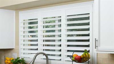 white shutters above a kitchen sink