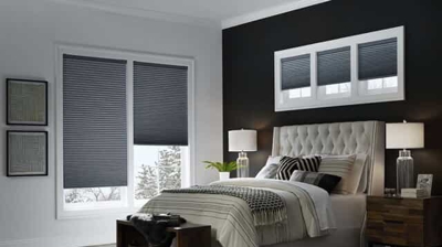room darkening honeycomb/ cellular shades in a bedroom in a dark gray blue color